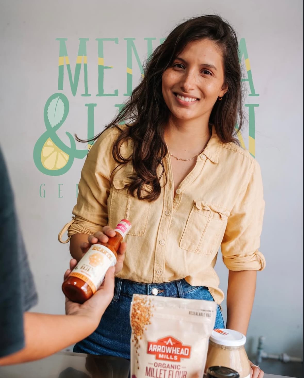 Smiling girl with Mentha & Limón products