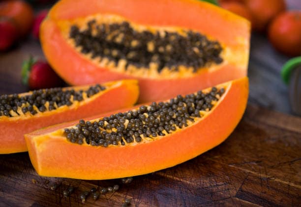 Organic papayas cut in half showing seeds